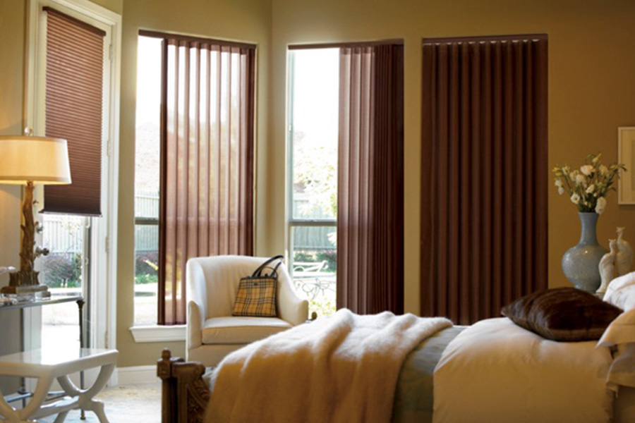 Choose durable and high-quality fabric or vinyl vertical blinds in Salt Lake City. Maroon fabric vertical blinds inside a bedroom