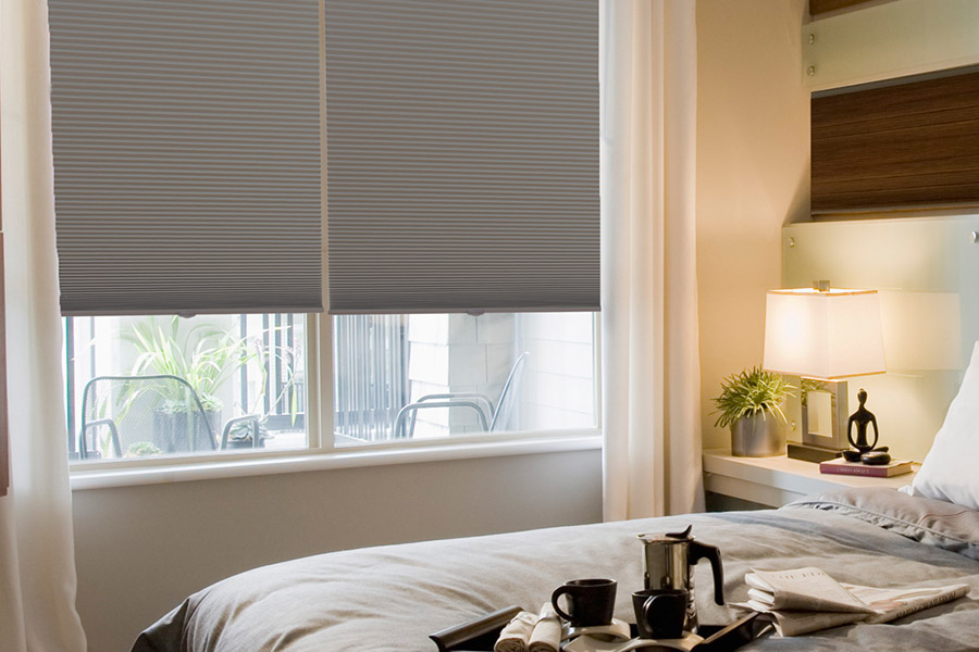 Gray cellular shades on bedroom windows