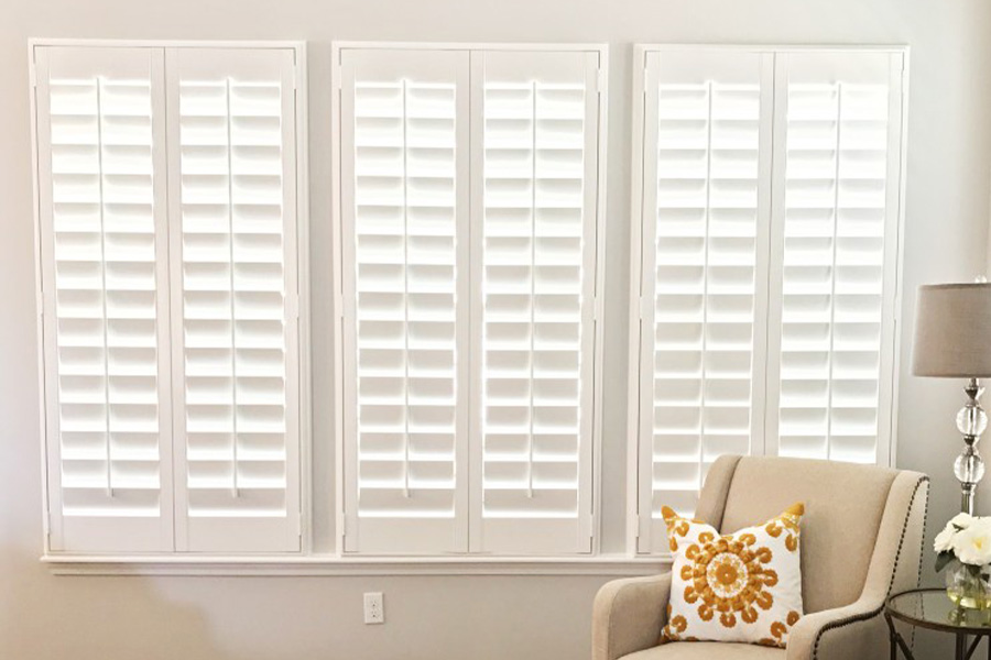 Outside-mounted Polywood shutters on a living room window